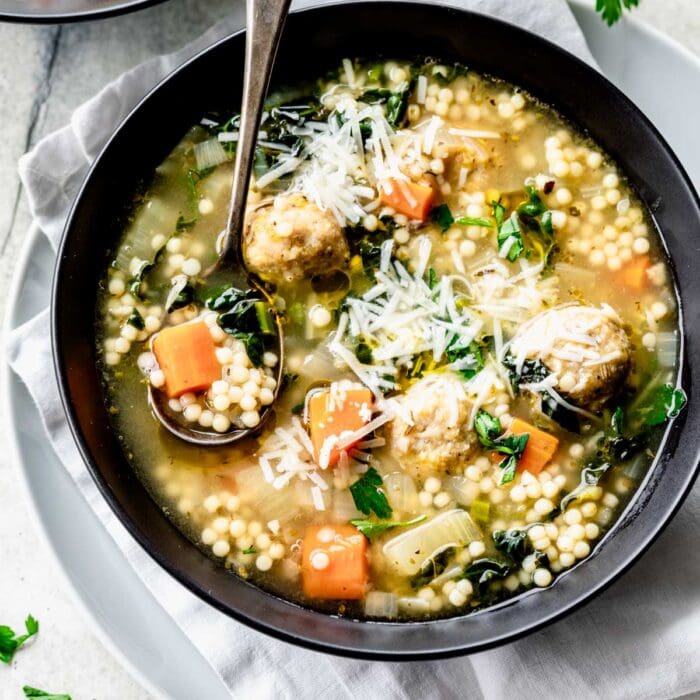 a black bowl with Italian Wedding Soup made with chicken meatballs