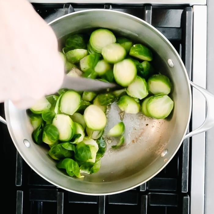 Add the steamed Brussels sprouts, salt and pepper, and stir to coat.