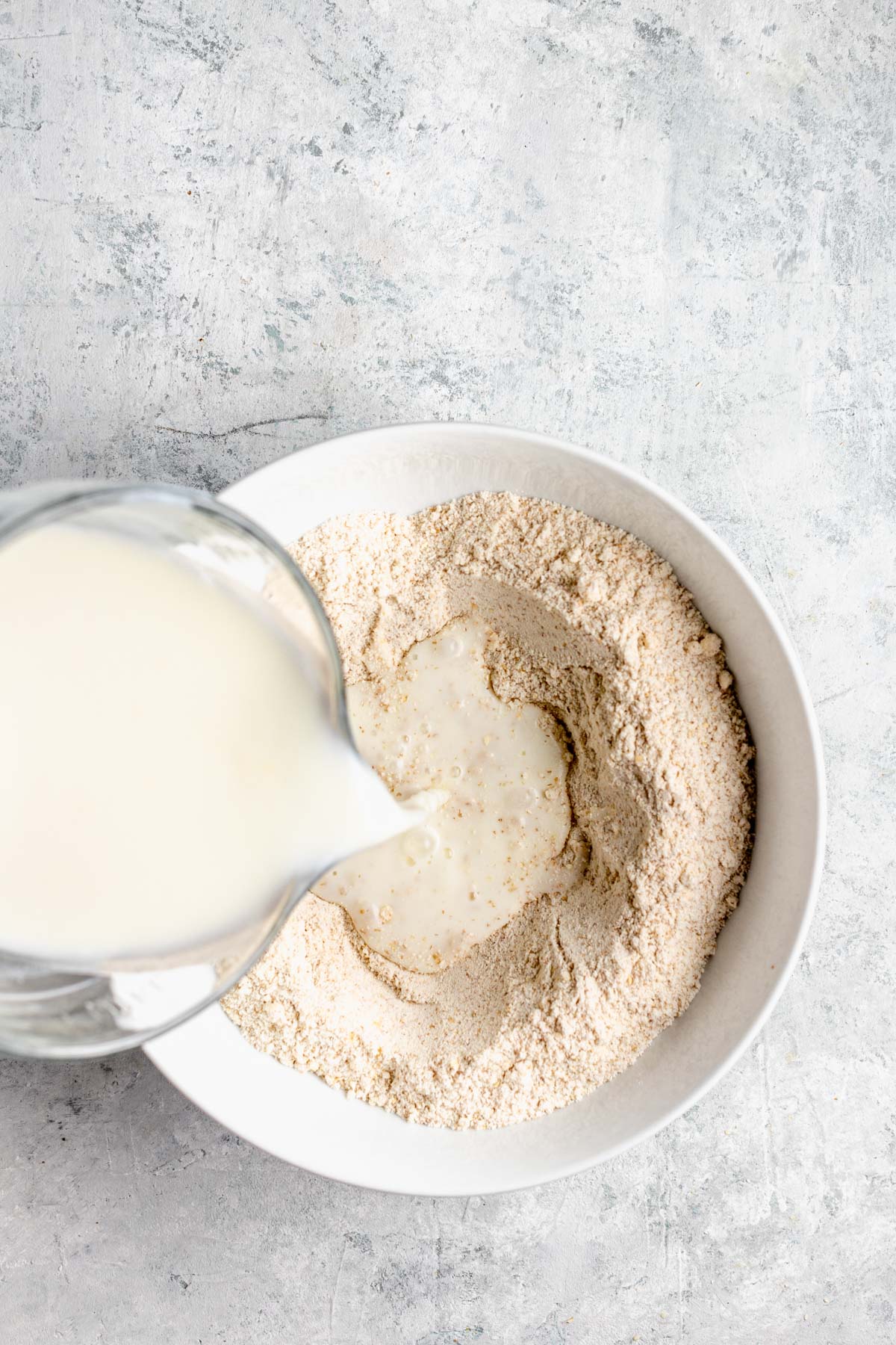 pouring the buttermilk mixture into the dry mix