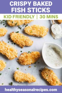 a sheet pan with baked fish fingers on it and a ramequin of tartar sauce