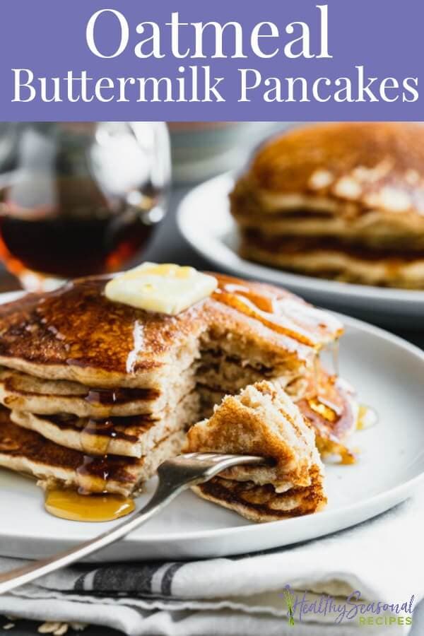 a large stack of pancakes with syrup and butter