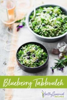 blueberry quinoa tabbouleh on a white and peach cloth with violets