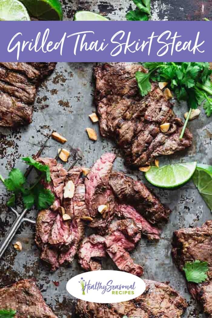 Grilled steak on a baking sheet with cilantro and peanuts on top