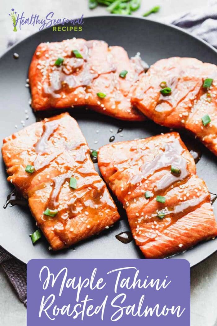 a black plate with salmon filets on top