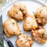 overhead of white platter with six honey mustard chicken thighs on it