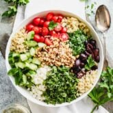 A bowl topped with Mediterranean ingredients