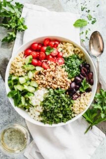 A bowl topped with Mediterranean ingredients