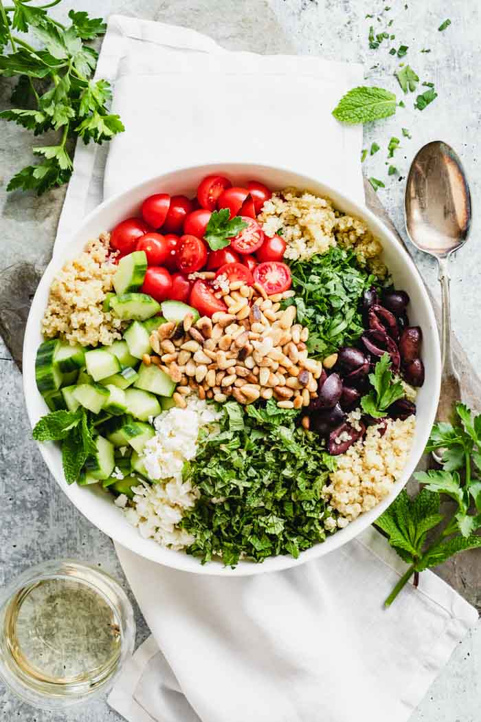 A bowl topped with Mediterranean ingredients
