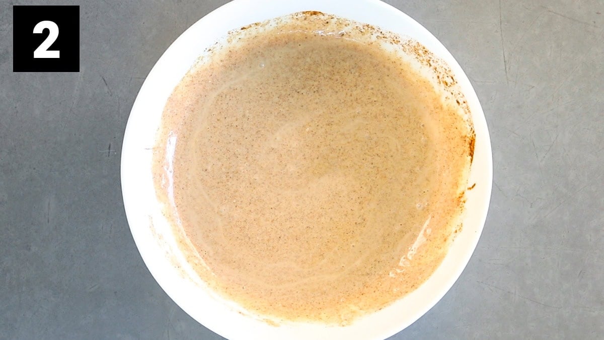 the dressing in a white bowl