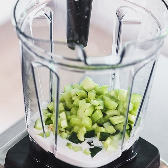 Coconut milk, ginger, chopped cucumber and celery in a blender