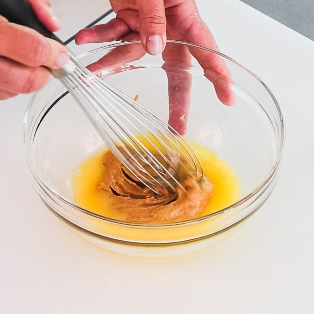 whisking the orange juice and peanut butter