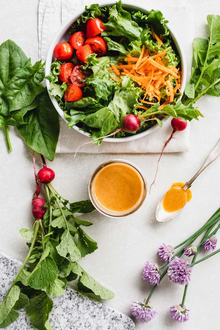 Peanut Dressing in a jar from overhead with salad and vegetables