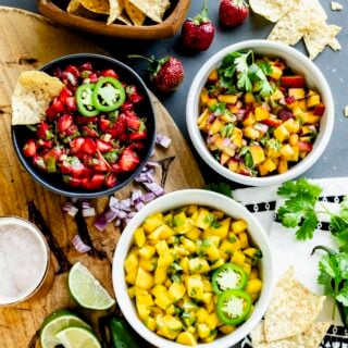 three bowls of salsa with chips and lime