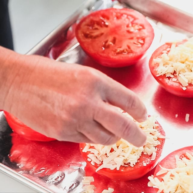 Top the tomatoes with the cheddar
