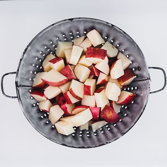 cut potatoes in a colander