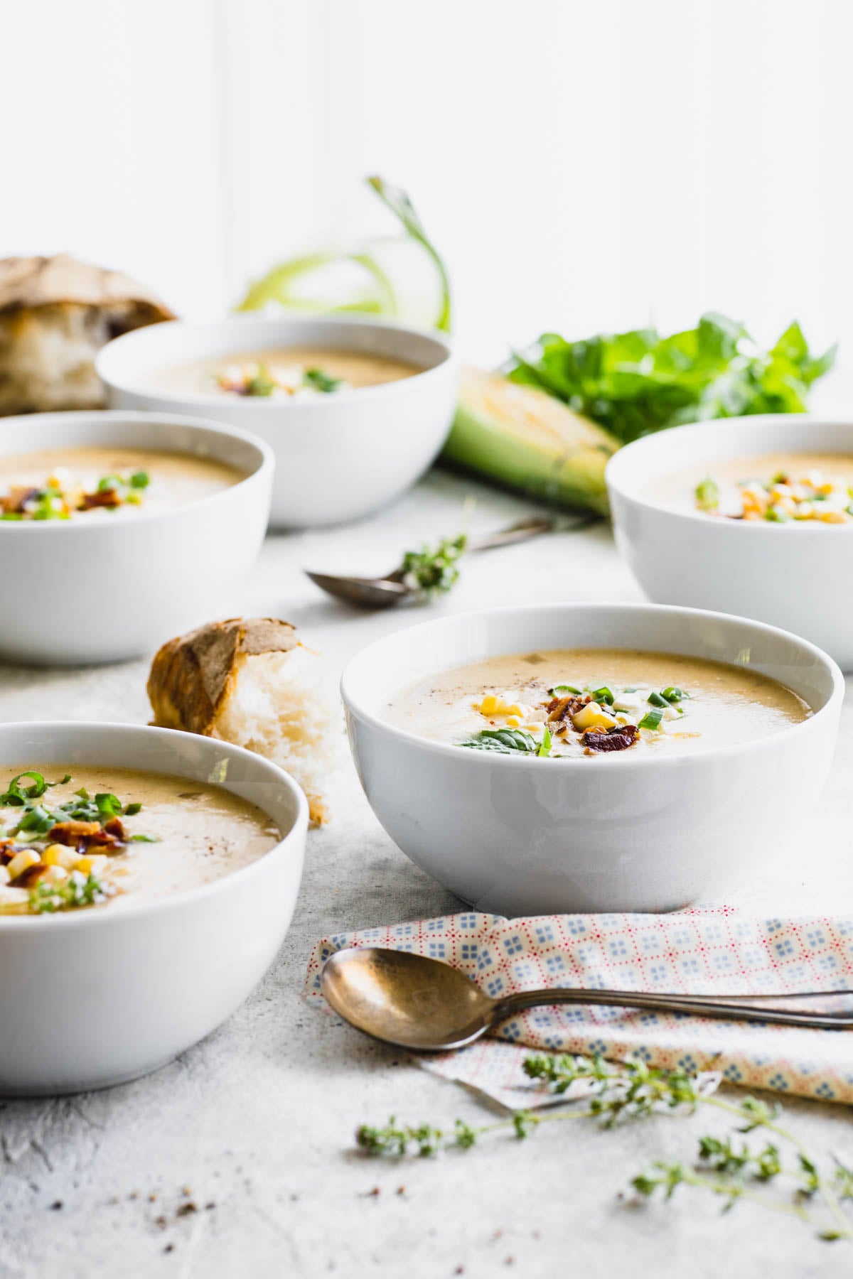 side view of bowls of chowder on a white table