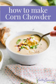 Corn chowder from the side, a spoonful held to camera with text overlay