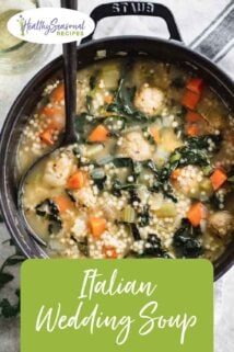 Italian wedding soup in a black pot with a ladle