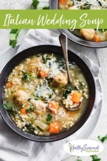 Italian wedding soup in a black bowl