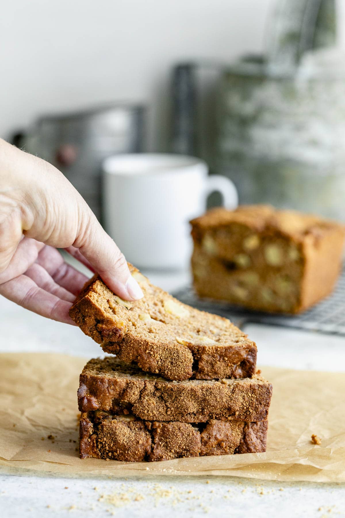 a stack of the bread and someone grabbing the top slice off