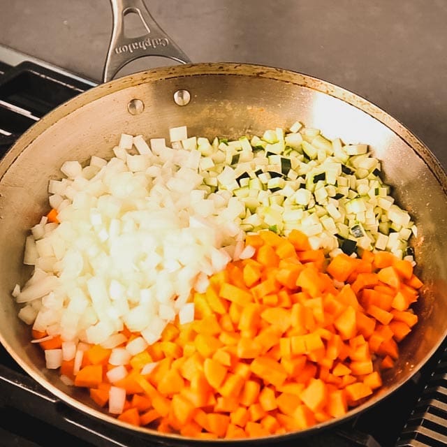 Diced onions, carrots and zucchini in a large skillet