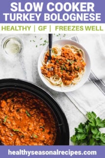 a crockpot of bolognese with a serving over pasta in a white bowl