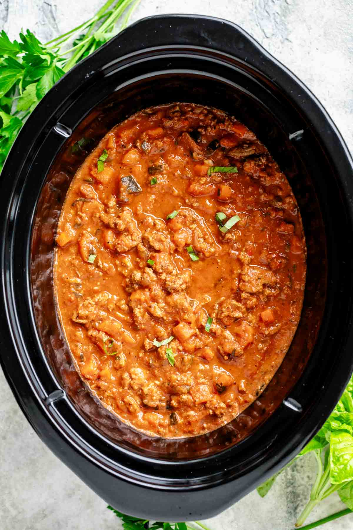 the insert for the slow cooker with bolognese in it