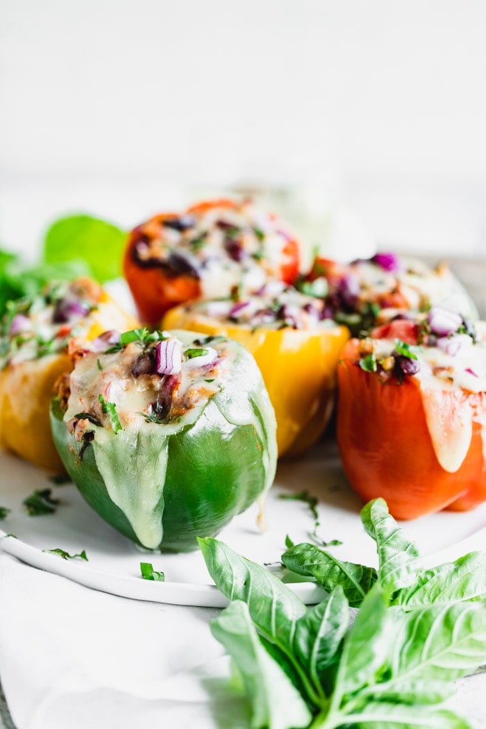 Stuffed peppers from the side with cheese melted over them