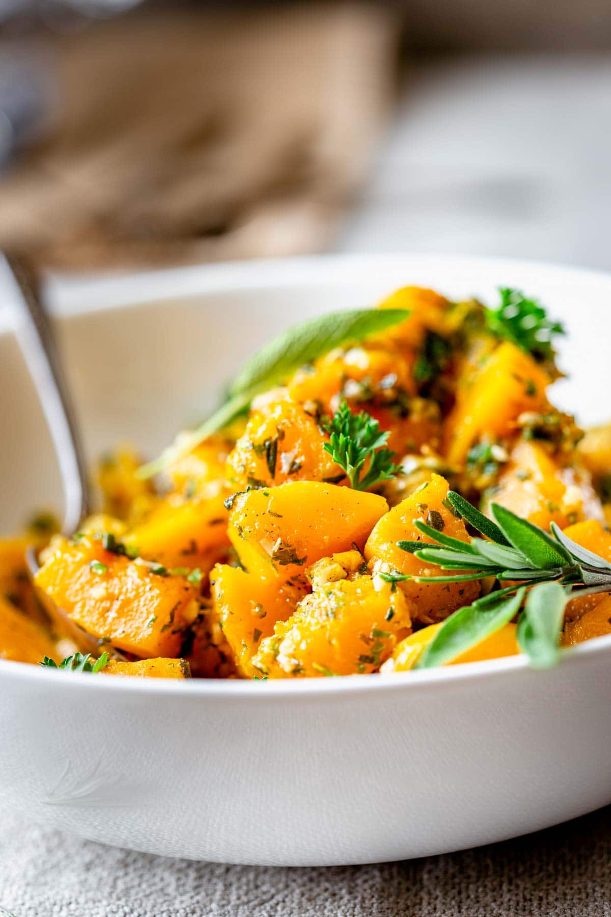 side view of the bowl of squash with a spoon in it