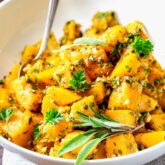 cubes of butternut squash in a white bowl