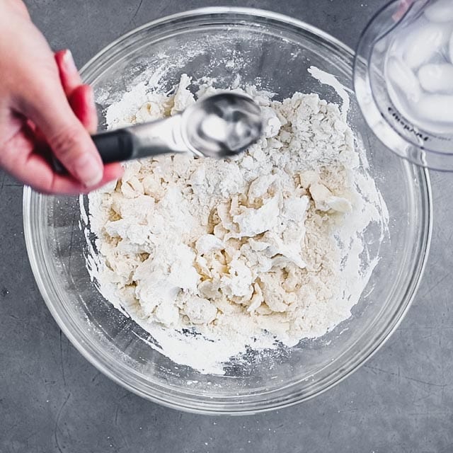 adding ice water to the butter and flour mixture