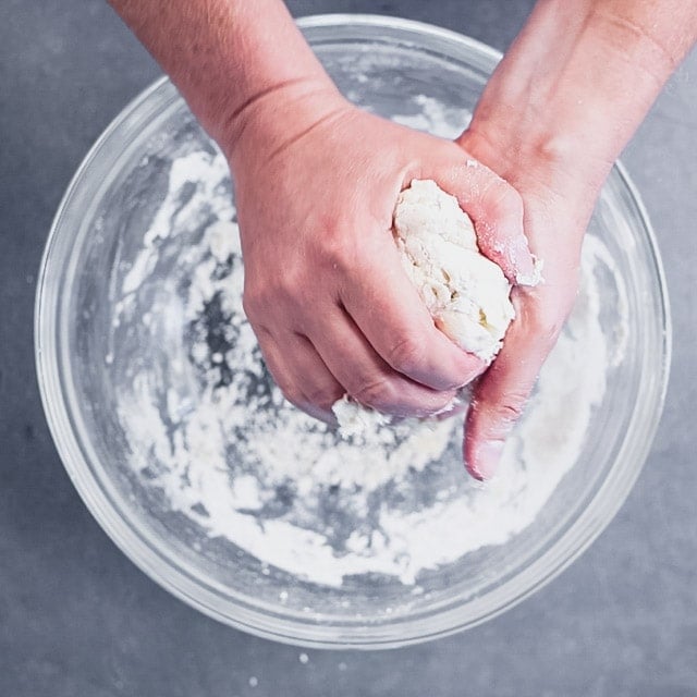 gather dough into a single ball by squeezing it together