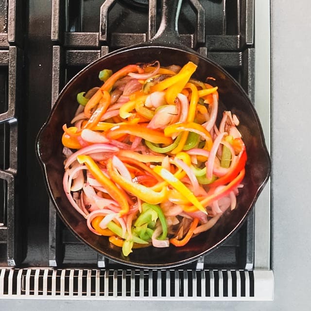 Cook the peppers and onion in the skillet to soften