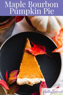 overhead of slice of pie with Bourbon bottle and white pumpkin