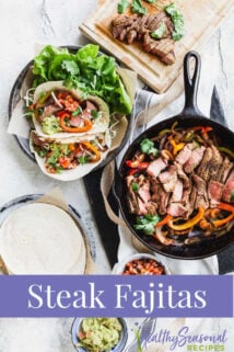 Sirloin steak fajitas on a table with a skillet of peppers and onions, tortillas and condiments