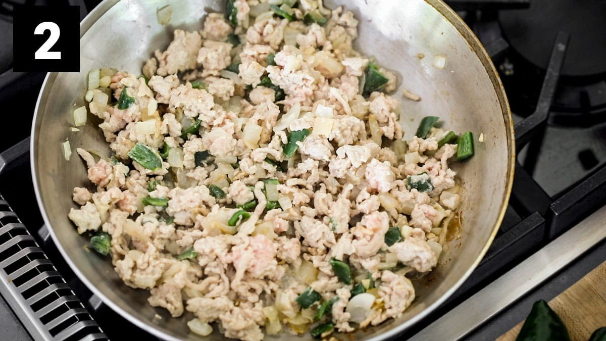 the cooked ground chicken and poblano peppers in the skillet (before the spices are added)