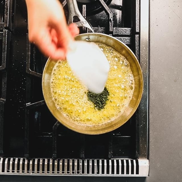 Add the chopped herbs to the garlic butter mixture
