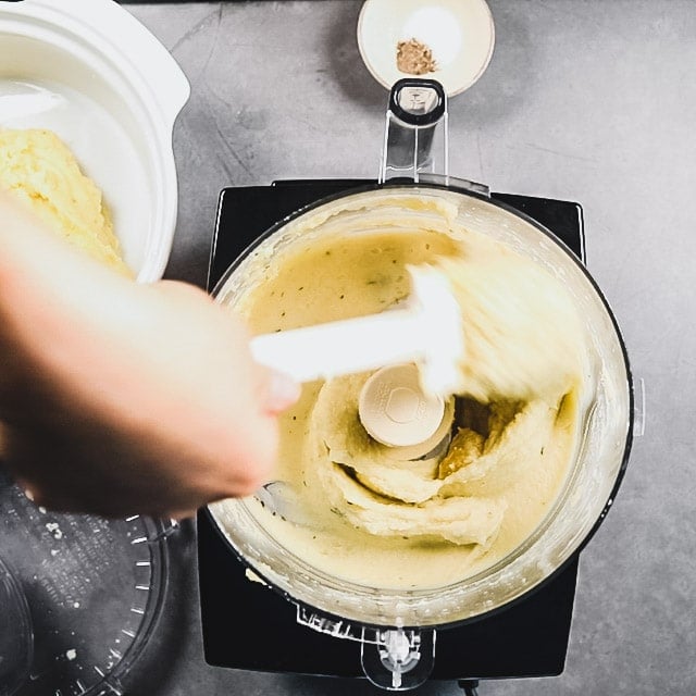 scraping the sides of the food processor