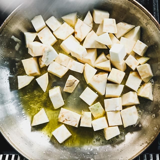 Melt the butter in a large skillet. Add olive oil and swirl to combine. Add the celery root and cook, stirring occasionally until it is browned in spots.