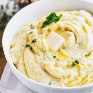 root veggie puree in a bowl with butter
