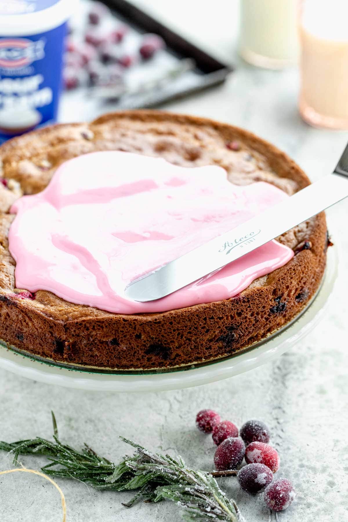Use an offset spatula to spread the cranberry glaze over the cake.