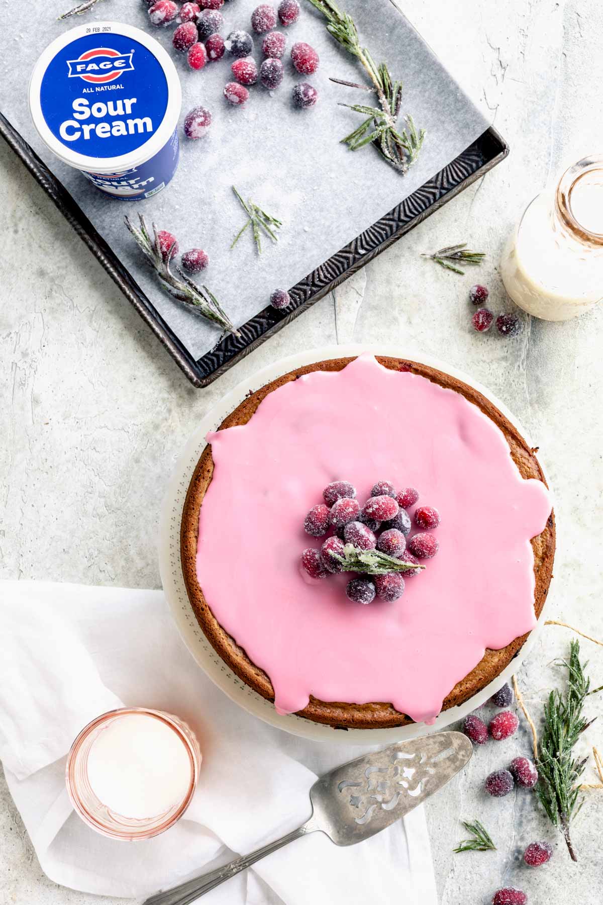 adding cranberries to the top of the cake