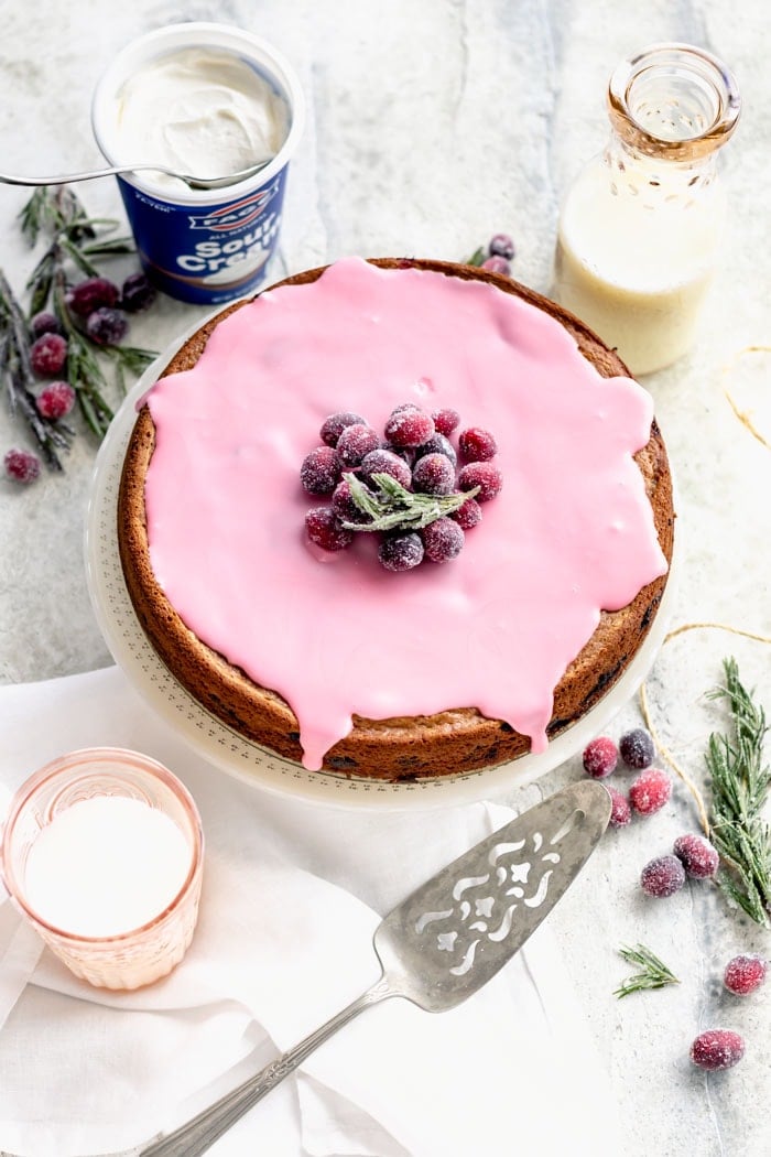 a table from overhead with cranberry cake and a spatulal