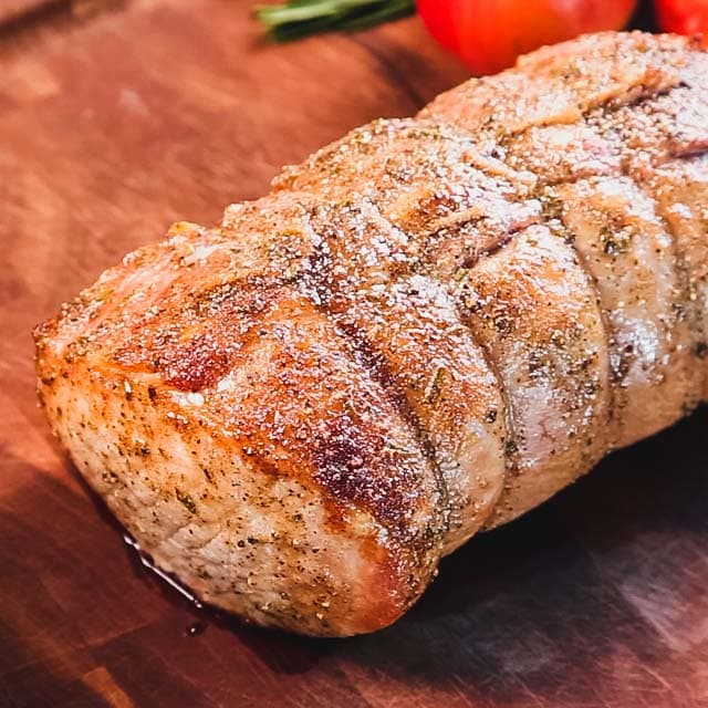 the pork resting on a carving board