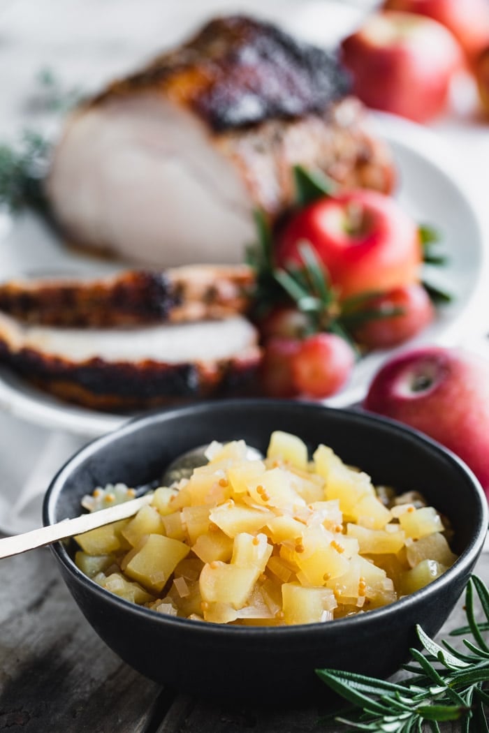 apple chutney, closeup in a black bowl
