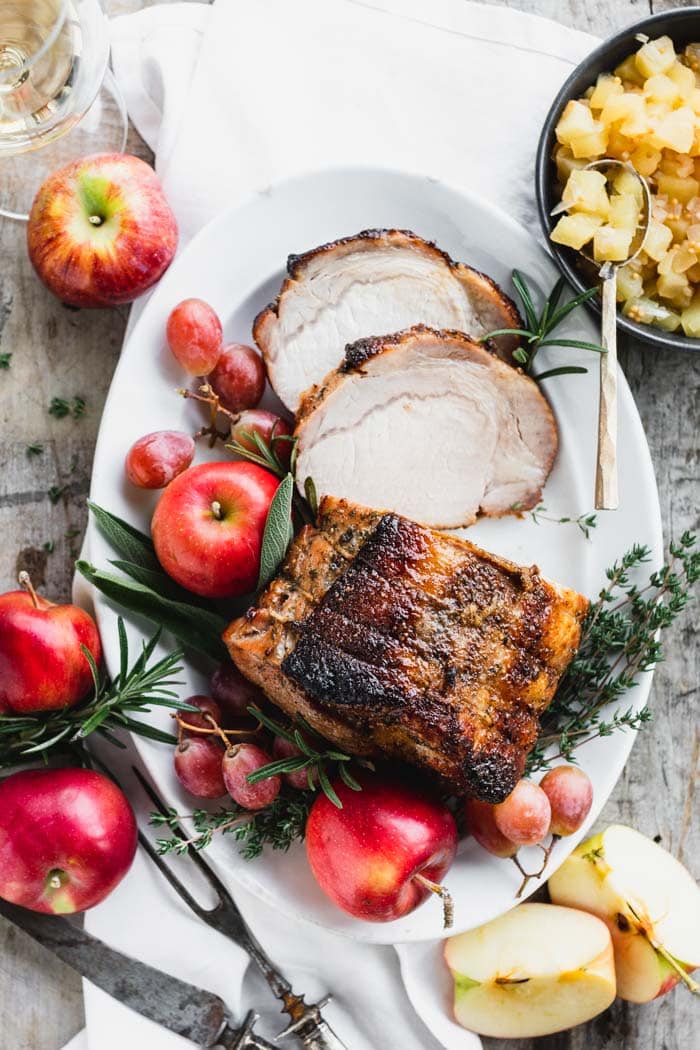 overhead view of platter with pork loin and garnishes