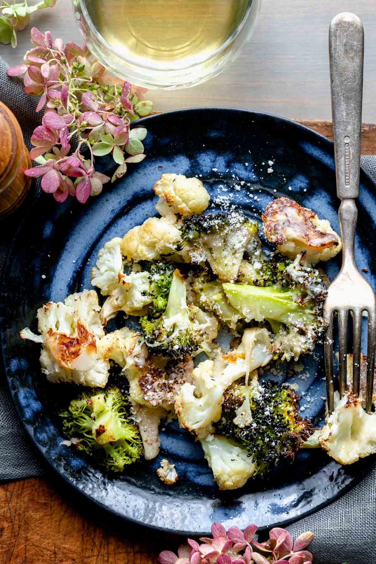 cauliflower and broccoli on blue plate with hydrangeas