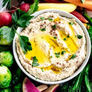 cauliflower hummus in a bowl with oil on top