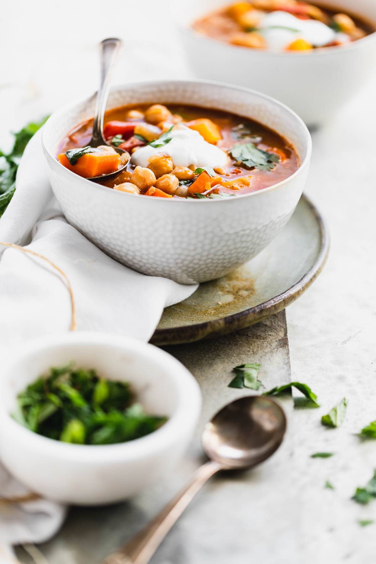 bowls of stew from the side with herbs