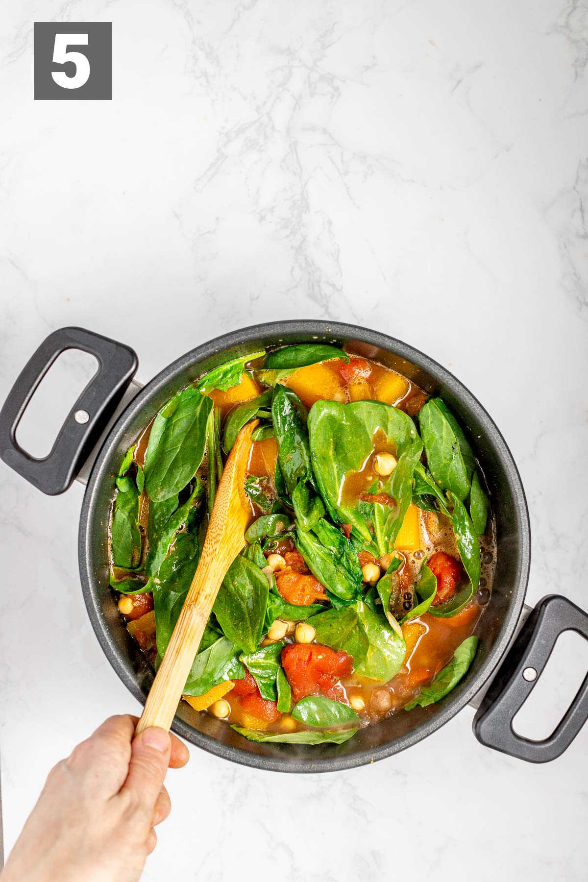 stir the spinach in